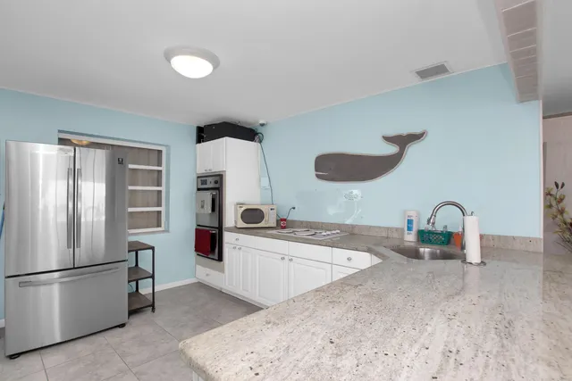 an aerial view of a house with a yard and lake view