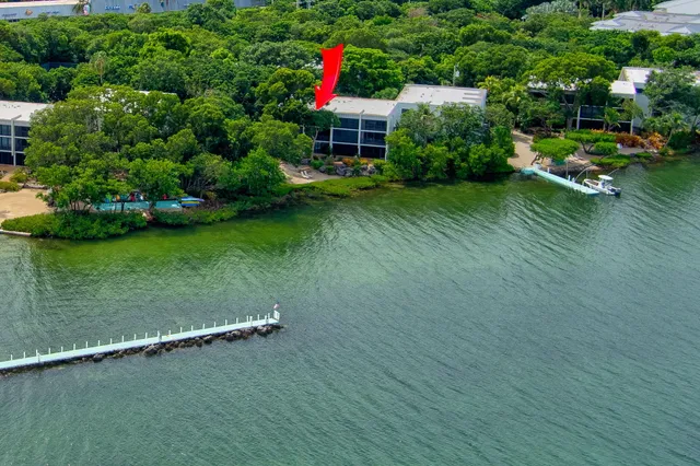 a kitchen with kitchen island a sink appliances and a counter top space