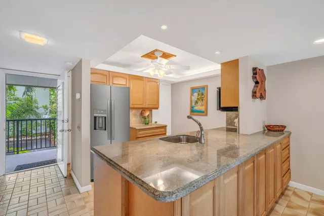 a kitchen with a sink a counter top space and cabinets
