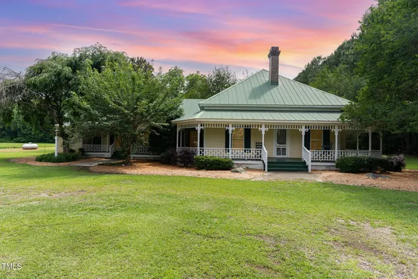 a front view of a house with swimming pool having outdoor seating