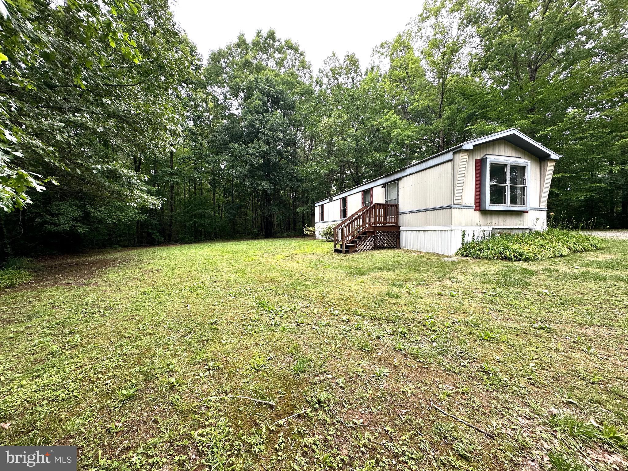 606 Dogwood Acres Road Bumpass, VA 23024 - Photo 18 of 20 a house with trees in the background