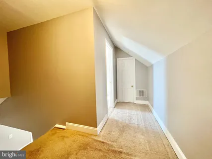 a view of a big room with closet and windows