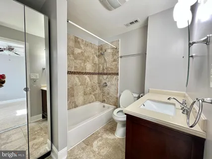 a bathroom with a bathtub and a sink