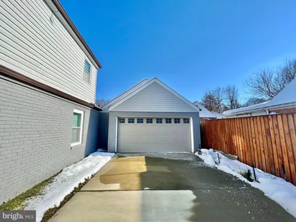 a view of house with backyard and garage