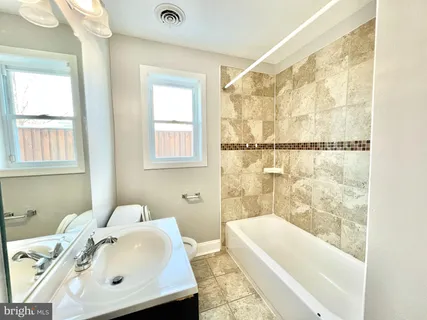 a bathroom with a sink and a bathtub