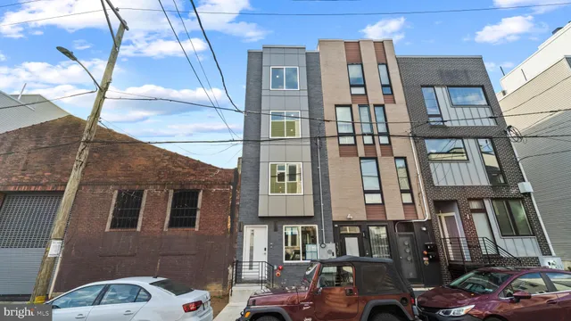 a front view of a residential apartment building with a yard