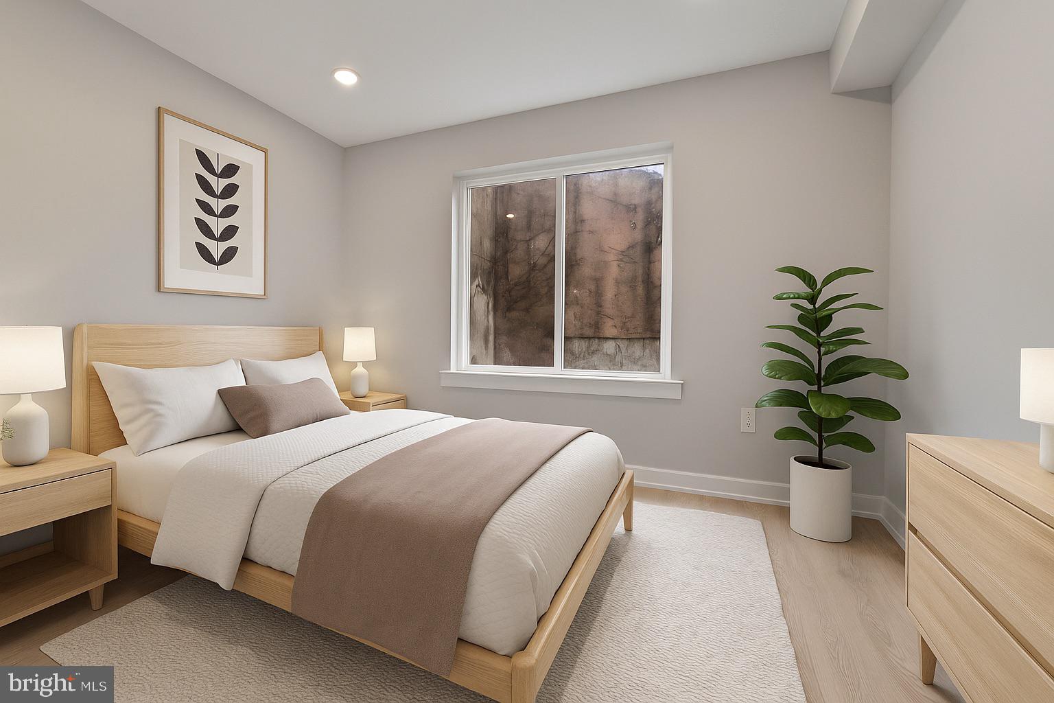 1432 Ogden Street, Unit 1 Philadelphia, PA 19130 - Photo 13 of 17 a bedroom with bed and a potted plant