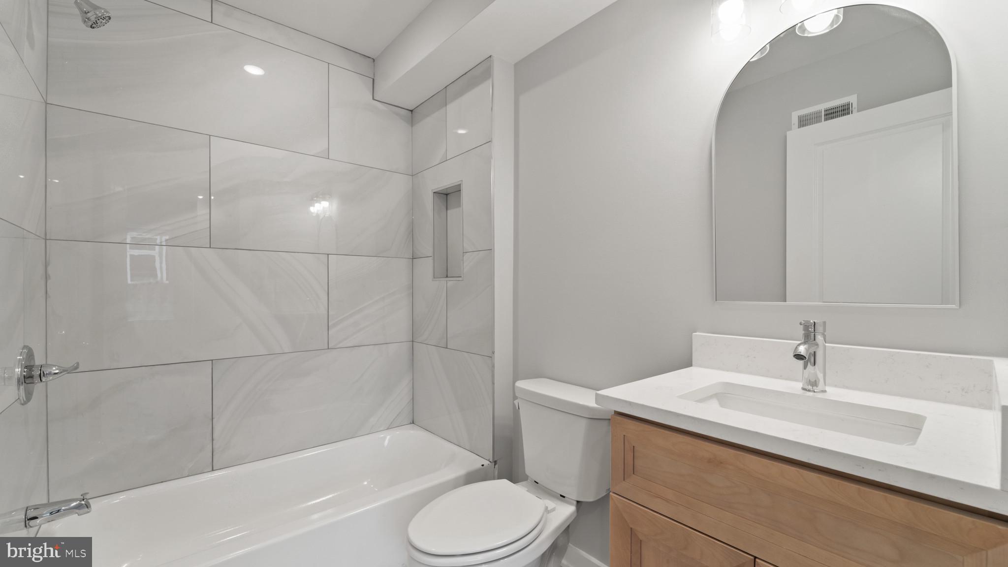 1432 Ogden Street, Unit 1 Philadelphia, PA 19130 - Photo 14 of 17 a bathroom with a sink a toilet and shower