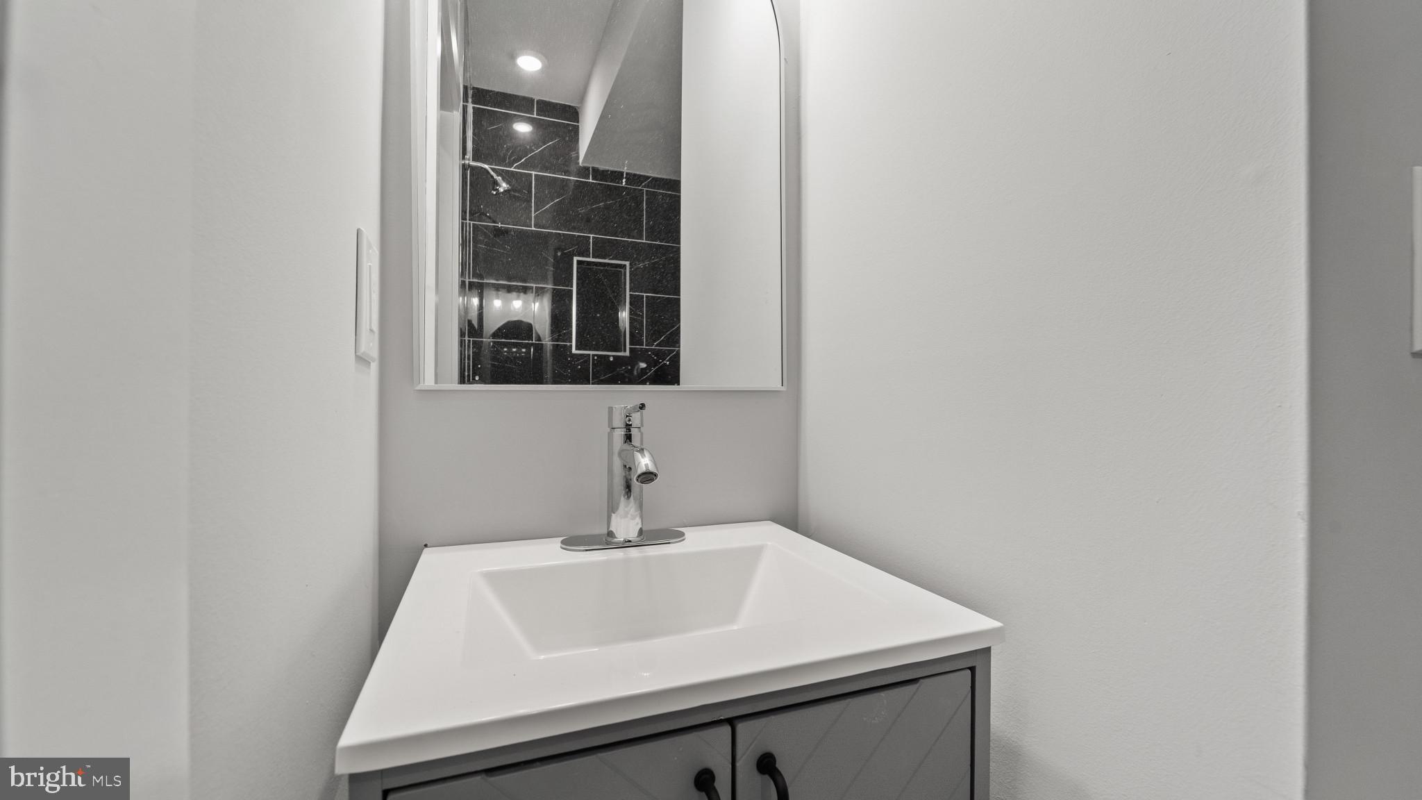1432 Ogden Street, Unit 1 Philadelphia, PA 19130 - Photo 17 of 17 a bathroom with a sink and mirror