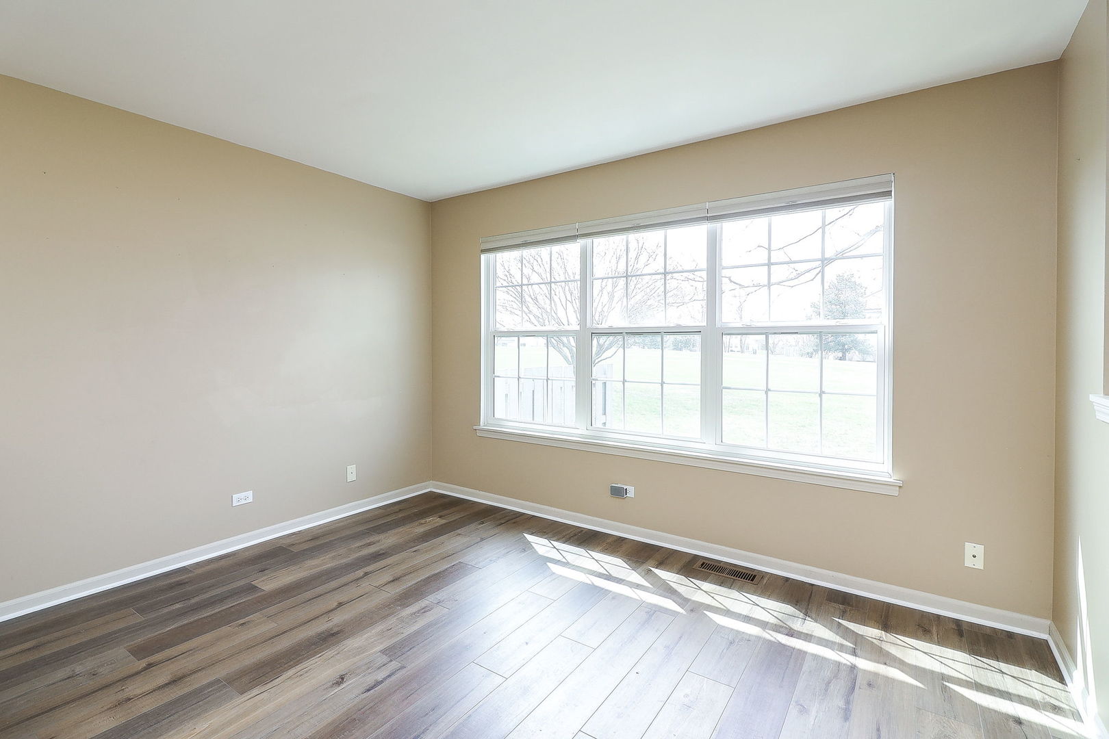1302 Filly Lane Bartlett, IL 60103 - Photo 12 of 29 an empty room with wooden floor and windows
