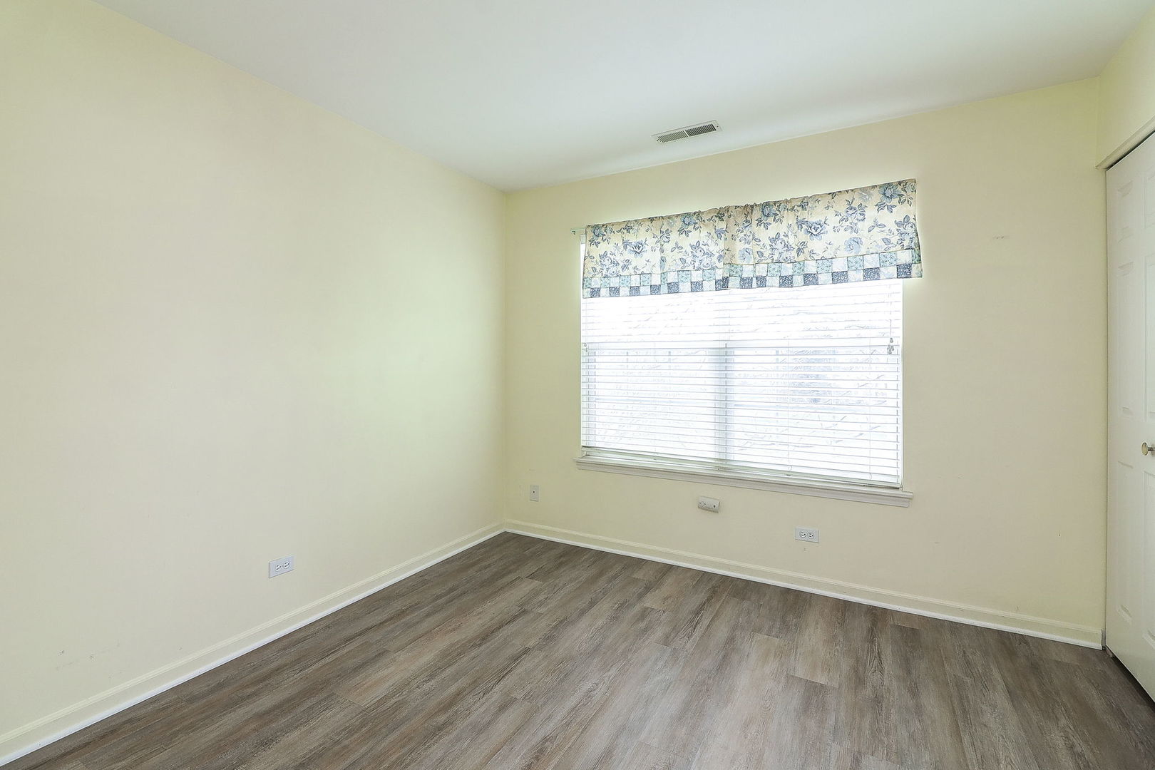 1302 Filly Lane Bartlett, IL 60103 - Photo 18 of 29 an empty room with wooden floor and windows