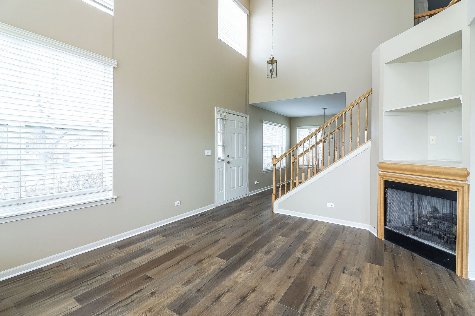 1302 Filly Lane Bartlett, IL 60103 - Photo 5 of 29 a view of an empty room with wooden floor fireplace and a window