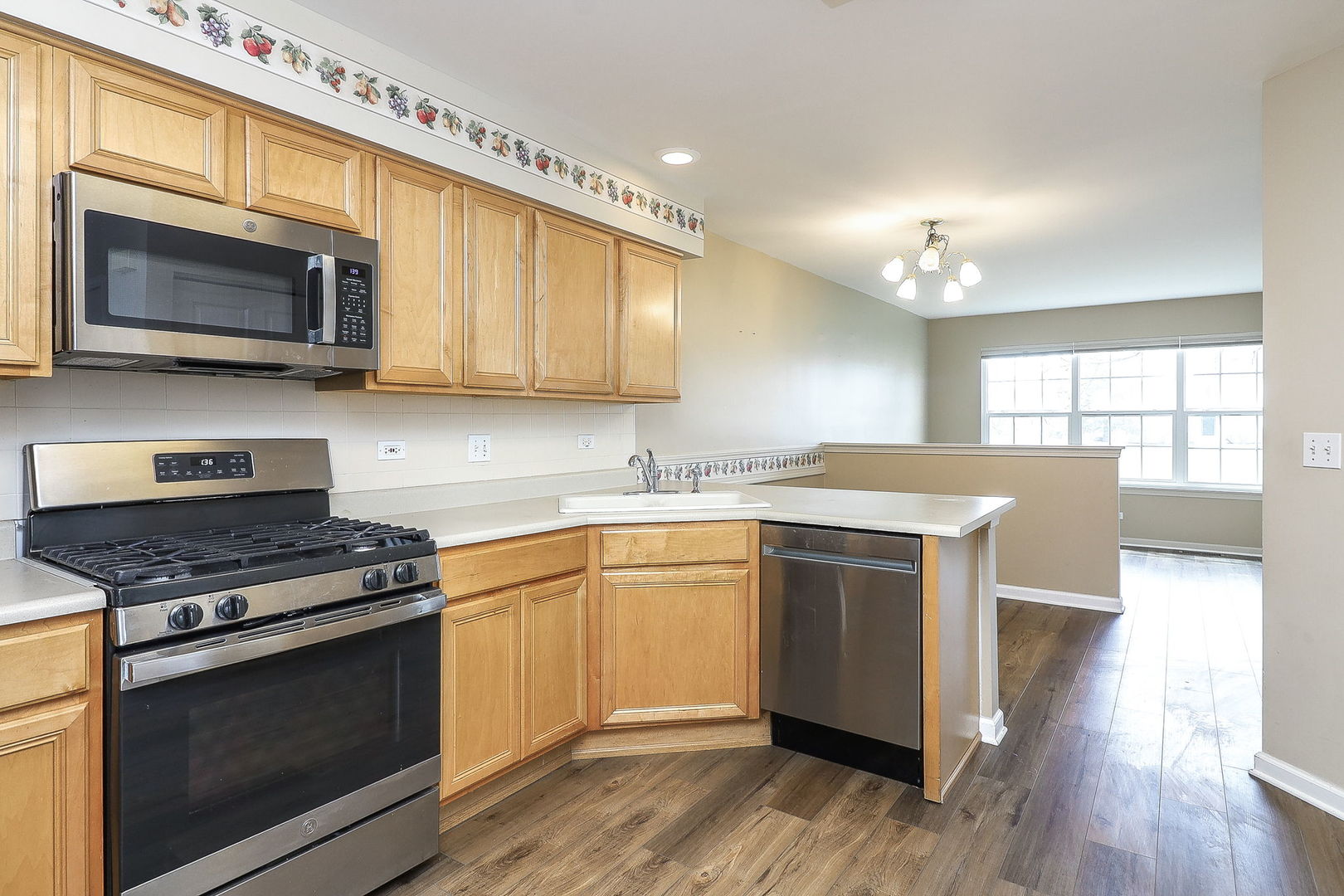 1302 Filly Lane Bartlett, IL 60103 - Photo 7 of 29 a kitchen with stainless steel appliances granite countertop a stove and a microwave