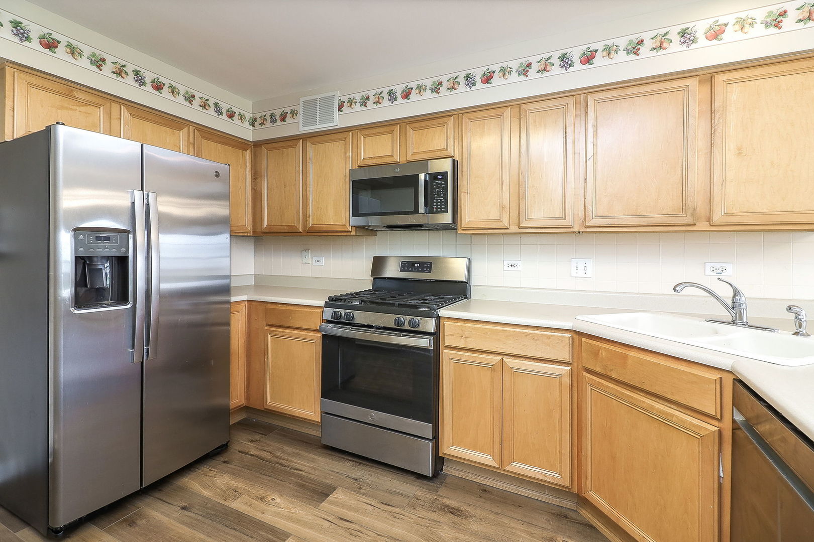 1302 Filly Lane Bartlett, IL 60103 - Photo 8 of 29 a kitchen with stainless steel appliances granite countertop a refrigerator sink and stove