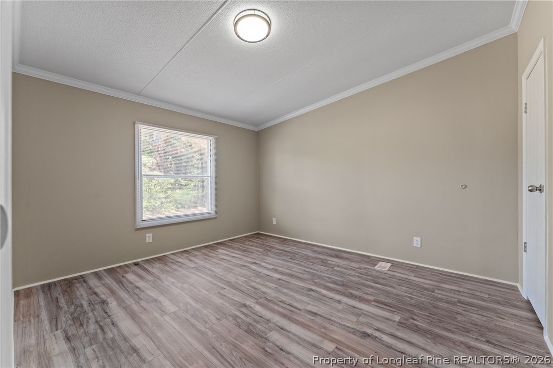 515 Mt Zion Road Red Springs, NC 28377 - Photo 17 of 50 an empty room with wooden floor and windows