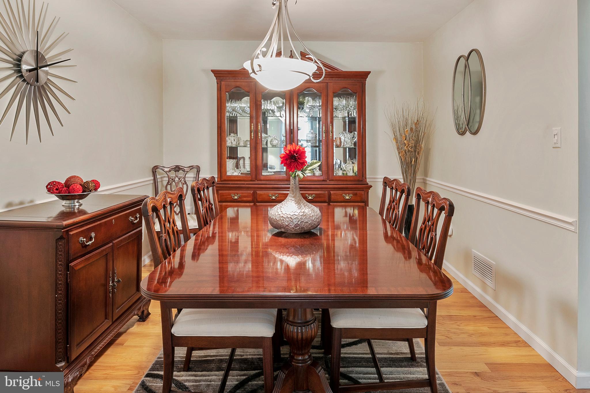 754 Oldfield Point Road Elkton, MD 21921 - Photo 12 of 49 a view of a dining room with furniture a chandelier and wooden floor