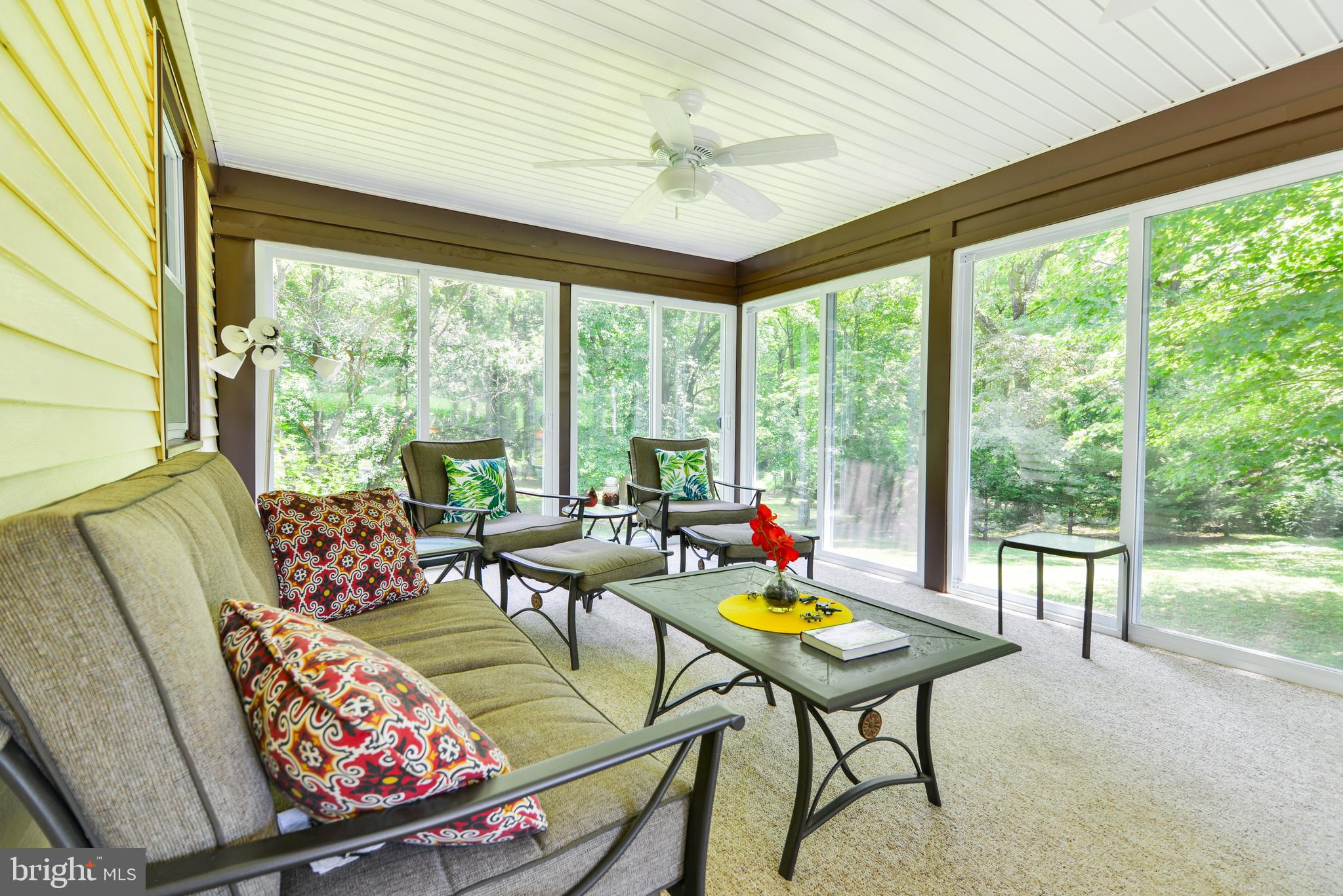 754 Oldfield Point Road Elkton, MD 21921 - Photo 22 of 49 a living room with furniture and a floor to ceiling window