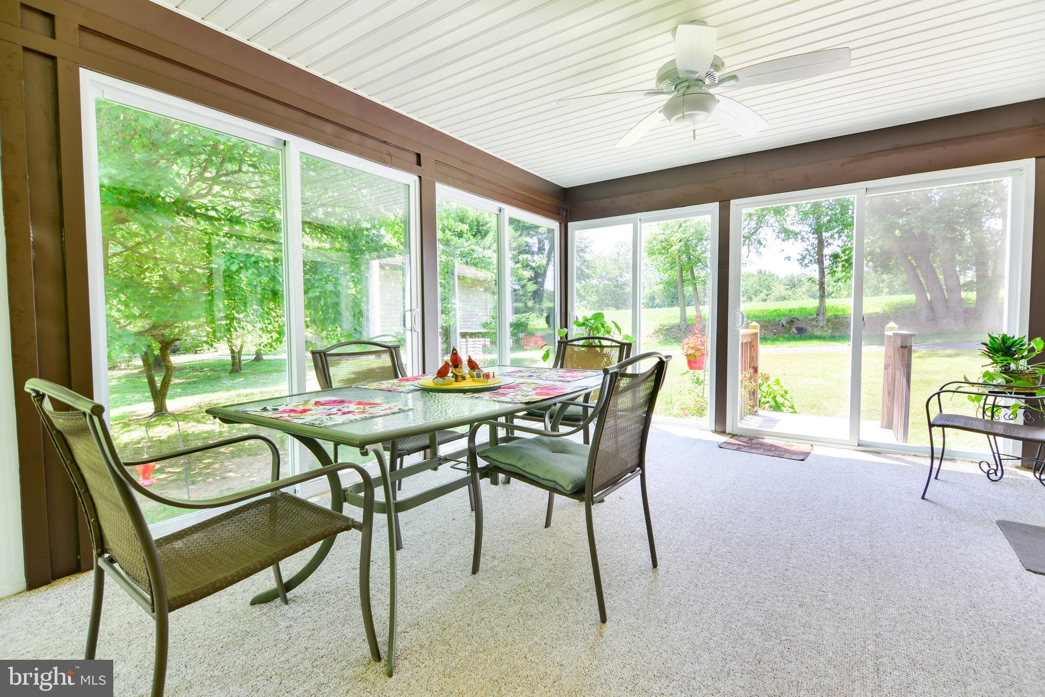 754 Oldfield Point Road Elkton, MD 21921 - Photo 23 of 49 a dining room with furniture and a floor to ceiling window