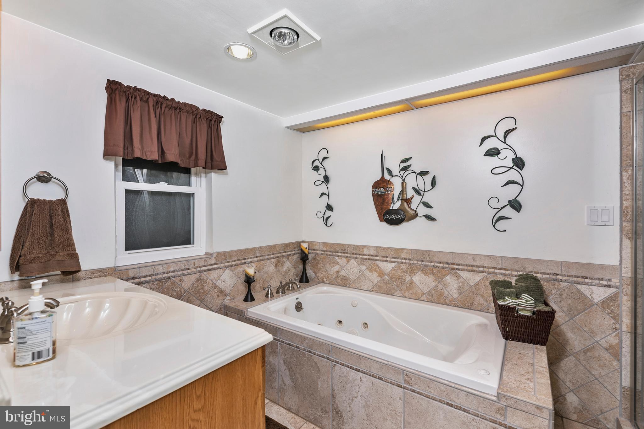 754 Oldfield Point Road Elkton, MD 21921 - Photo 36 of 49 a bathroom with a tub and a sink