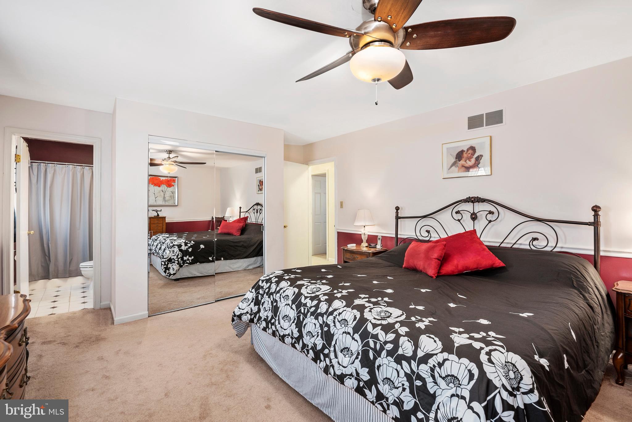 754 Oldfield Point Road Elkton, MD 21921 - Photo 38 of 49 a bedroom with a large bed and a chandelier