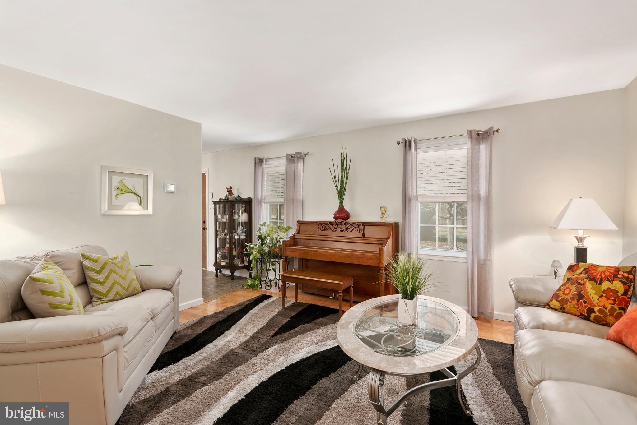 754 Oldfield Point Road Elkton, MD 21921 - Photo 8 of 49 a living room with furniture and a lamp