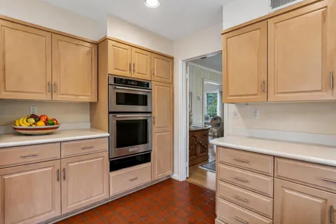 a kitchen with granite countertop white cabinets and stainless steel appliances