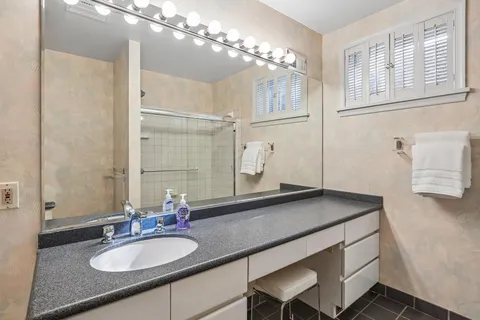a bathroom with a sink double vanity and a mirror