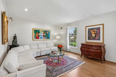 a living room with furniture a rug and a window