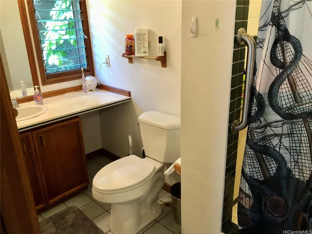 a bathroom with a toilet a sink and a window