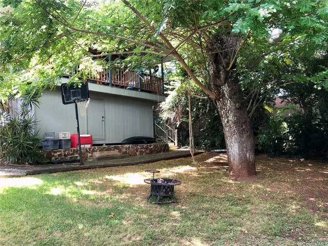 a view of a fire pit with large trees
