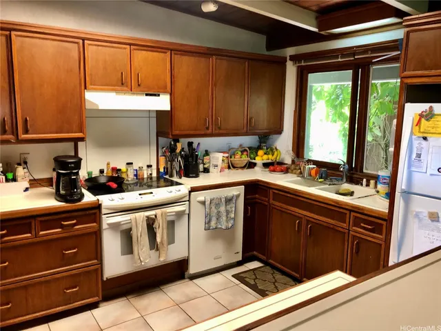 a kitchen with a sink cabinets and window