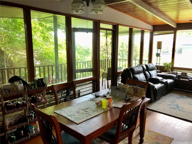a view of a dining room with furniture and window