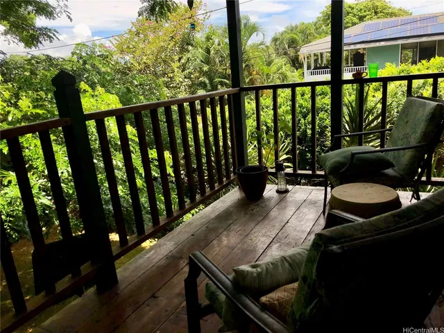 a view of balcony with wooden floor and outdoor seating
