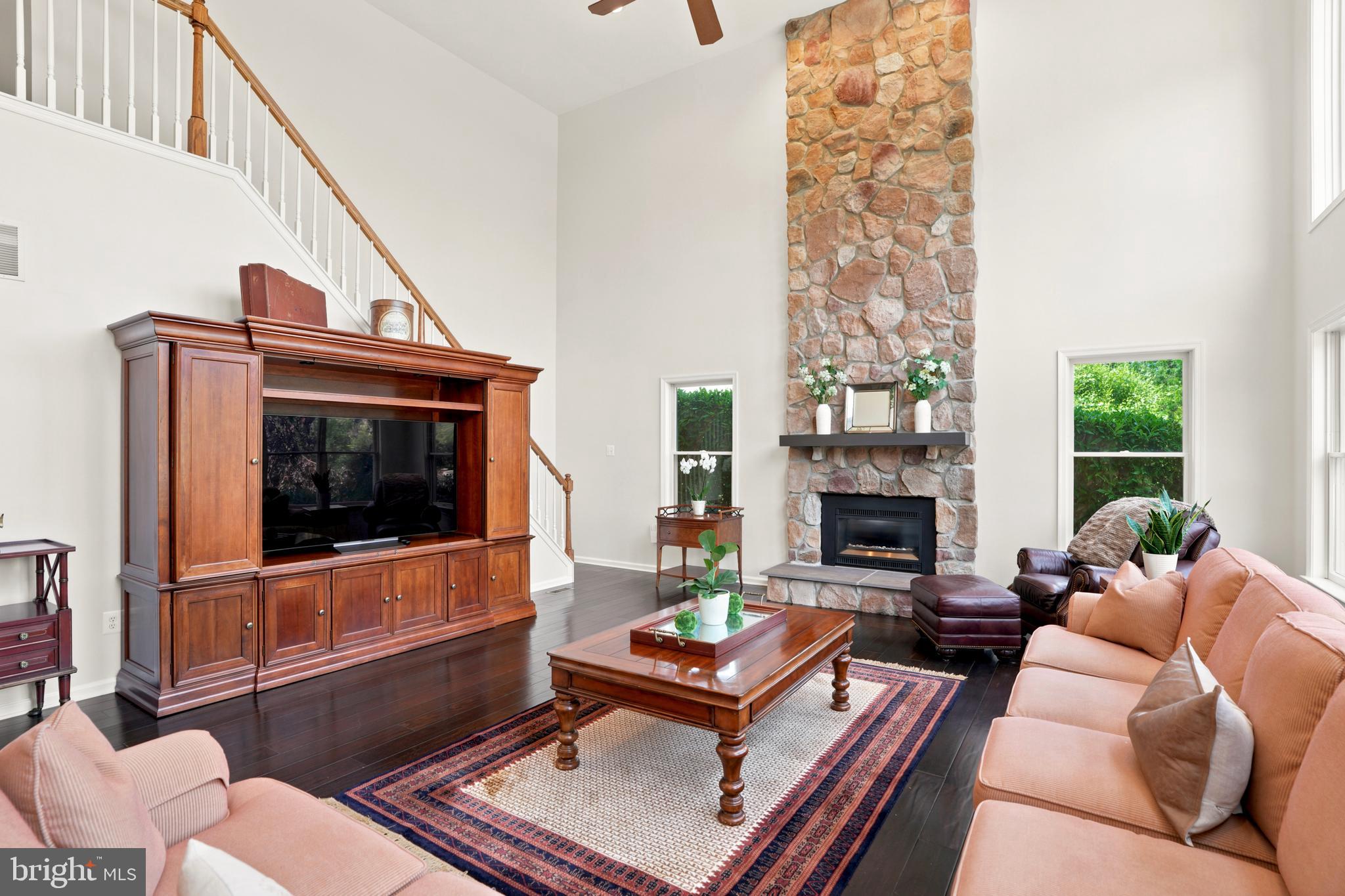 2303 Redtail Road Norristown, PA 19403 - Photo 21 of 53 a living room with furniture a flat screen tv and a fireplace