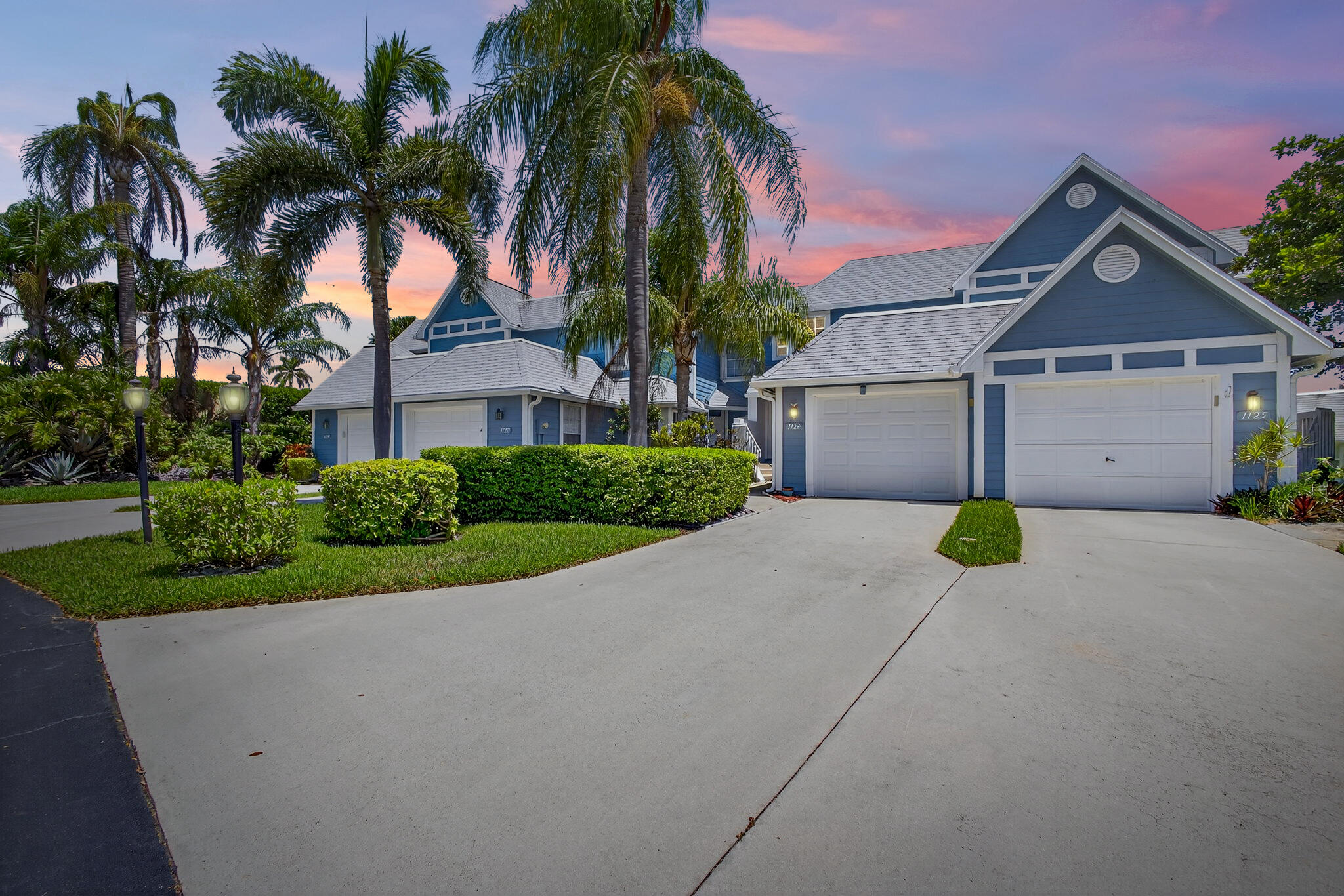 1126 Ocean Dunes Circle Jupiter, FL 33477 - Photo 3 of 24 a front view of a house with a garden