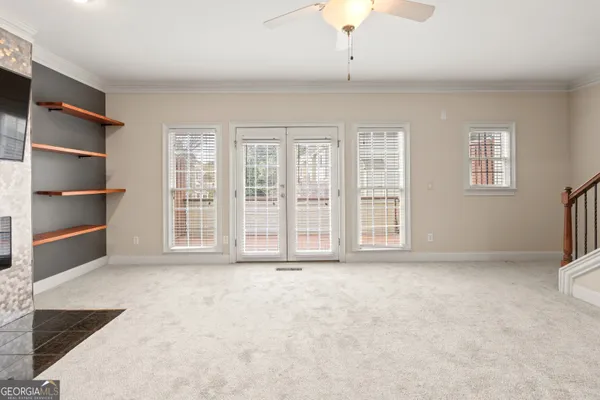 a living room with closet and a flat screen tv