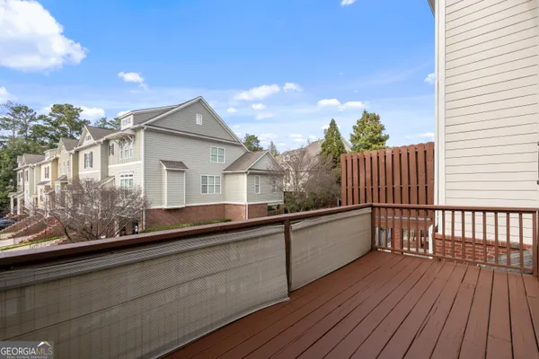 a view of a balcony with wooden floor and fence