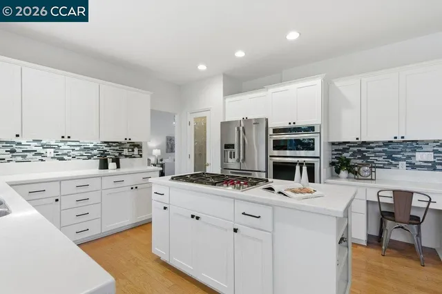 a kitchen with cabinets appliances and a counter space