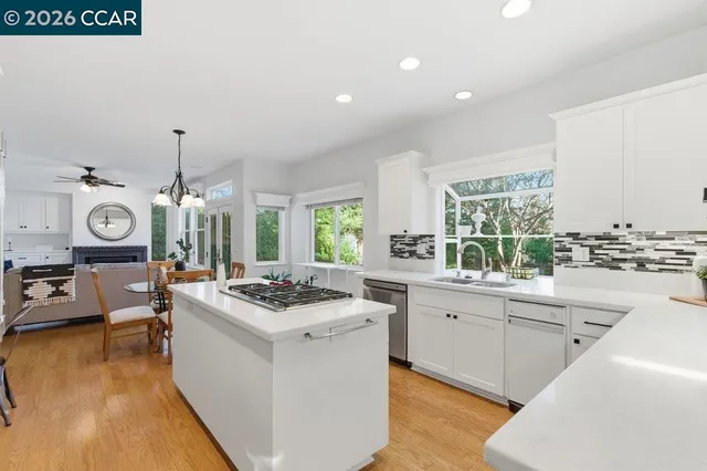 a kitchen that has a stove and a table in it