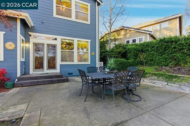 a view of a house with backyard and sitting area