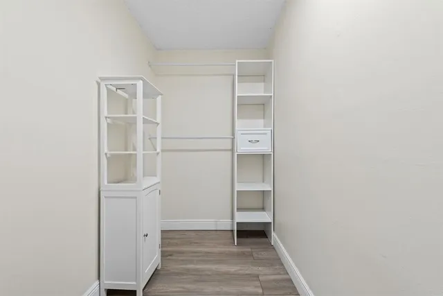 a view of walk in closet with empty racks