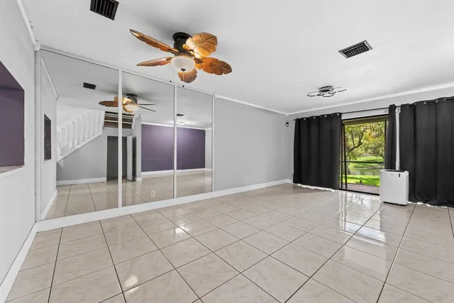 a view of a livingroom with a ceiling fan and window