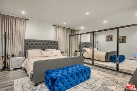 a bedroom with a large bed and a couch