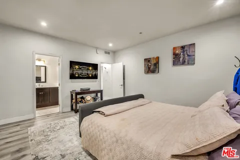 a bedroom with a bed and a television