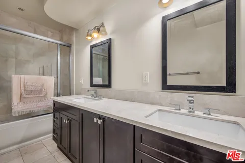 a bathroom with a sink double vanity and a mirror