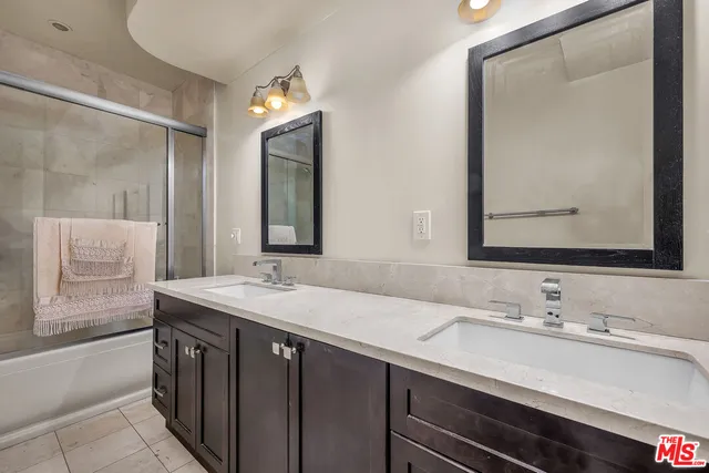 a bathroom with a sink double vanity and a mirror