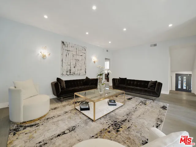 a living room with furniture and a rug