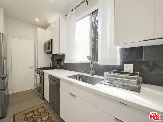 a kitchen with a sink stove and refrigerator