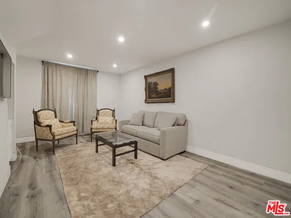 a living room with furniture and a rug
