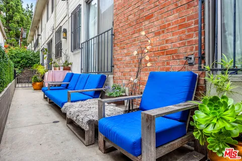 a blue bench sitting in front of a building